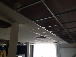 Tile installation begins in ground floor ceiling grid