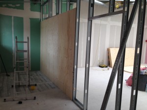 Wood panelling being fitted to inside of corridor space, for strength when mounting high speed fans