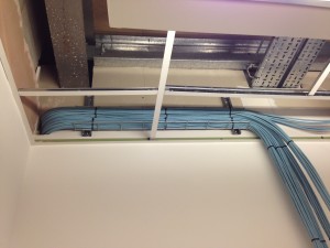 Office-side structured cabling tied off ready for entry into patching cabinet