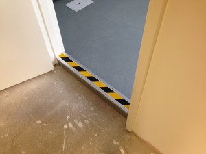 Safety measures installed on tanked floor thresholds between cold corridor and data hall