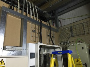 A look at additional cable containment and control above the primary distribution panels, and up the wall to reach the mains incomers
