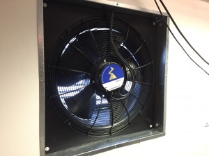 A look at a wired extract fan inside of its custom duct work